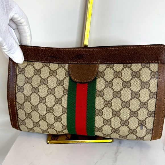 Gucci Handbags - Gucci Brown Monogram Canvas Clutch with Green and Red Web Stripe